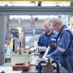 mature-and-younger-engineers-inspecting-turbine-bl-2022-03-04-01-47-19-utc